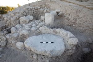Flat plastered stone installation and limestone pillar in the Azekah sun temple’s inner sanctuary