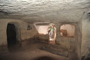 Interior room within the cave of Salome. A low chancel screen partitions the space, with an altar set up just beyond. Boaz Zissu, Bar-Ilan University