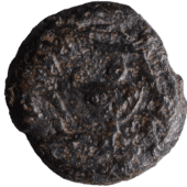 bronze coin bearing an amphora in shades or dark brown and black