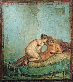 Wall painting of sexual intercourse with a man on bottom and woman on top. Teal background.