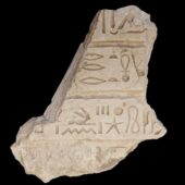 sandstone fragment with inscribed hieroglyphs on a black background. Courtesy Egyptian Ministry of Tourism and Antiquities