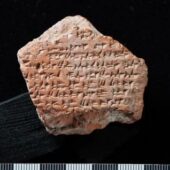 pentagon-shaped fragment of a cuneiform tablet positioned on a black background. Courtesy Turkish Ministry of Culture and Tourism.